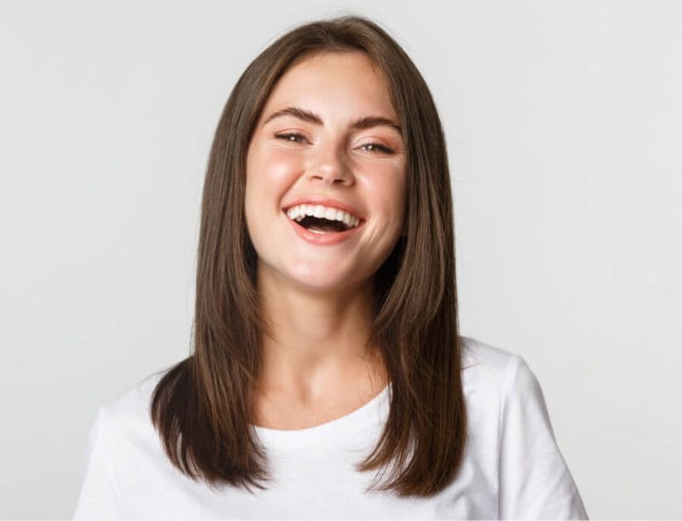 Relaxed, laughing patient showing how happy gas eases dental anxiety in Geelong