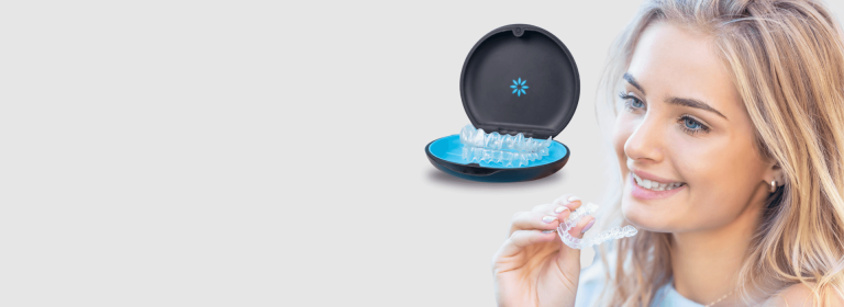 A clear Invisalign aligner tray held up during a dental consultation in Geelong