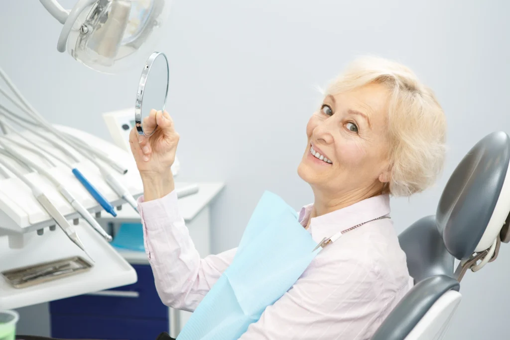 Dentist explaining a dental implant model to a patient in Geelong